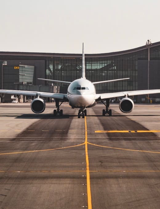 Passenger aircraft parked at an airport gate at dusk